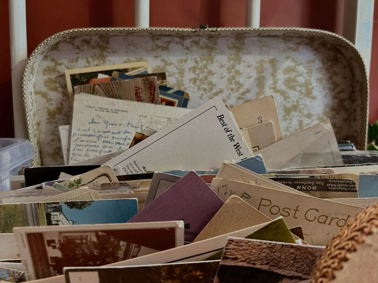 Vintage suitcase filled with collected travel postcards and handwritten mail